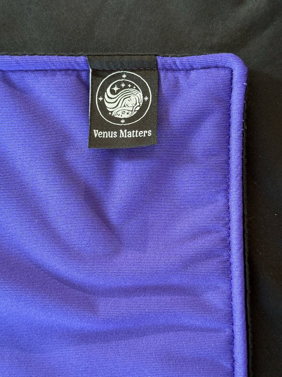 Purple backing, with certified safe waterproof layer hidden underneath the Black Pearl Purple Shell Venus Mat.